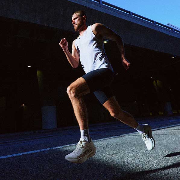 A man running outside wearing Brooks apparel